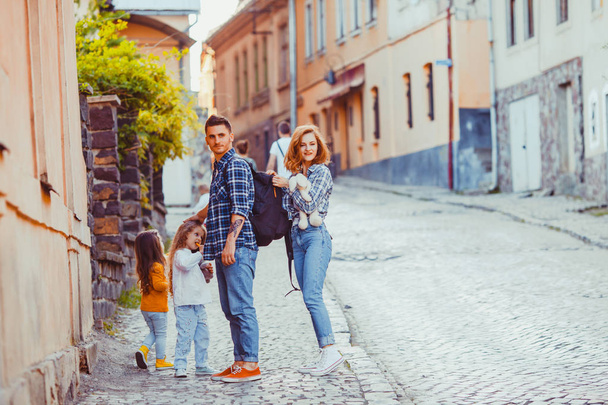 Lovely family of travelers standing on the ancient street - Fotografie, Obrázek
