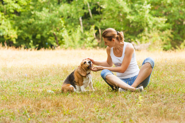 Picture of nice-looking woman with her well-bred dog - Foto, Imagen