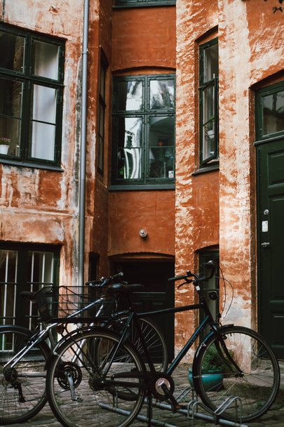 row of bicycles near old building at street of Copenhagen, Denmark - Photo, Image