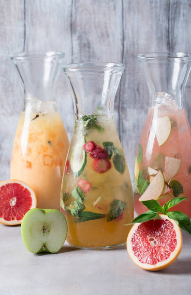 Set of citruslemonades: lemon with black currant, orange, lime and cranberry, grapefruit and bloody orange with ice and fruits - 写真・画像