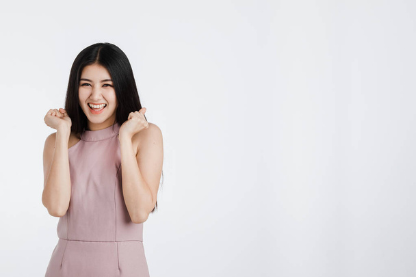 Beautiful young asian woman in pink dress, feeling very happy amazed excited surprised, portrait short isolated on white background. - Zdjęcie, obraz