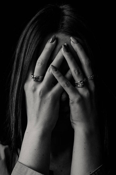 Woman closing her face with hands with rings - Fotoğraf, Görsel