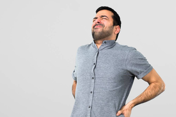 Handsome man with back pain on grey background - Photo, Image