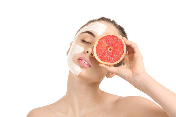 Beautiful young woman with facial mask and grapefruit on white background - Foto, imagen