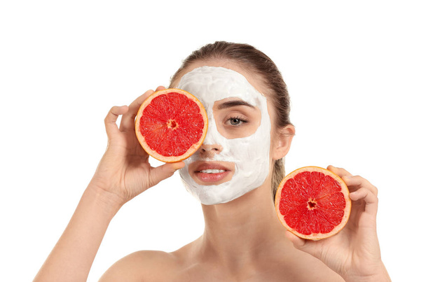 Beautiful young woman with facial mask and grapefruit on white background - Foto, afbeelding