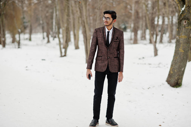 Stylish indian student man in brown suit and glasses posed at winter day outdoor. - Φωτογραφία, εικόνα