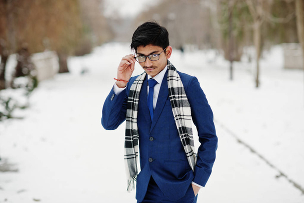 Stylish indian student man in suit, glasses and scarf posed at winter day outdoor. - Photo, image