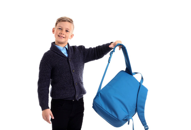 Cute little schoolboy with backpack on white background - 写真・画像