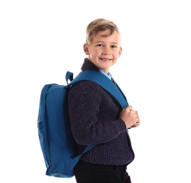 Cute little schoolboy with backpack on white background - Фото, зображення