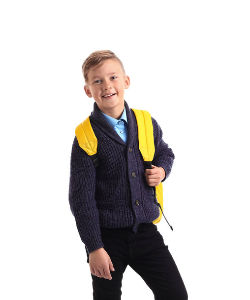 Cute little schoolboy with backpack on white background - Foto, Bild