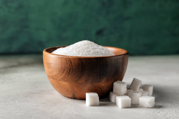 Bowl with sugar and cubes on light table - Photo, Image