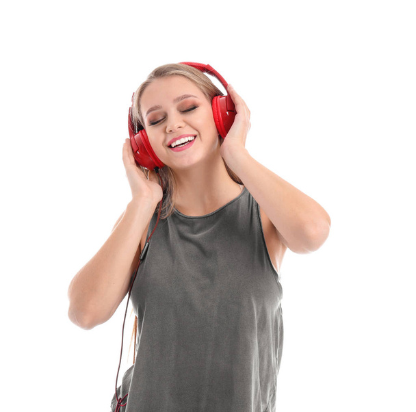 Beautiful young woman listening to music on white background - Photo, Image