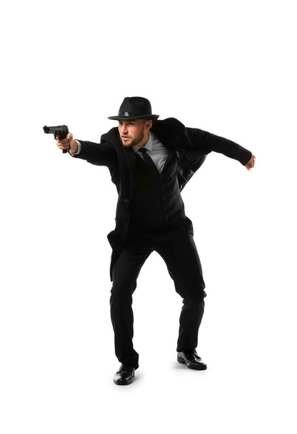 Detective with gun on white background - Фото, изображение