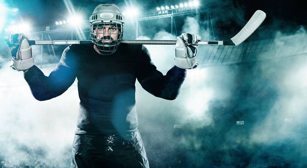 Ice Hockey player in the helmet and gloves on stadium with stick. - Foto, immagini