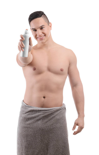 Young man with deodorant on white background - Φωτογραφία, εικόνα