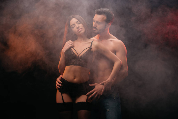 sexy couple hugging in smoky room - Zdjęcie, obraz