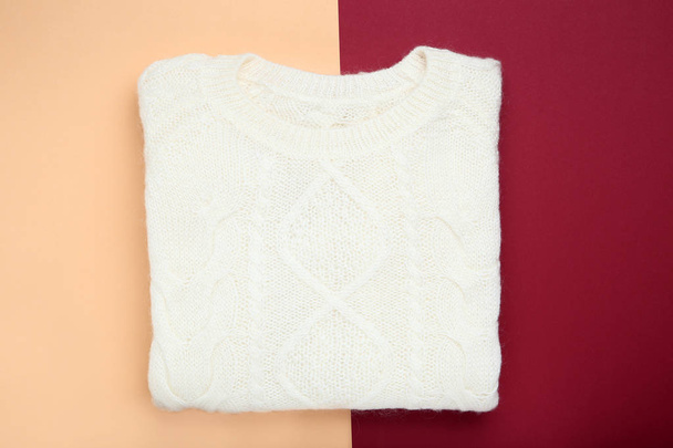 Folded white sweater on colorful background - Photo, Image