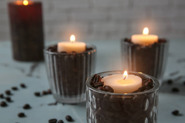 Burning candles in holders on table - Fotografie, Obrázek