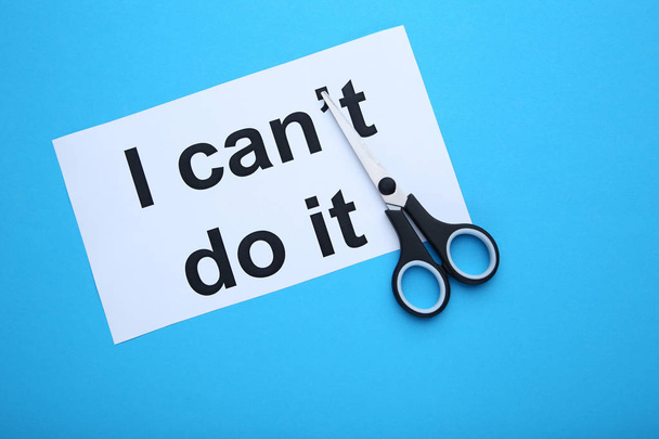 Paper with text I can't do it and scissors on blue background - Фото, изображение