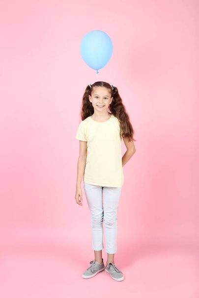 Cute young girl with balloon on pink background - Photo, Image