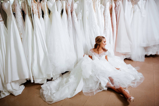 Female trying on wedding dress in a shop - Zdjęcie, obraz
