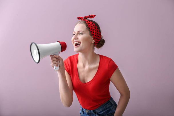Young woman with megaphone on color background - Fotografie, Obrázek