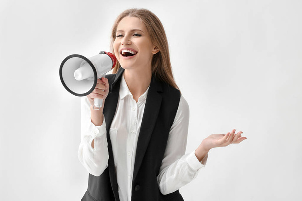 Businesswoman with megaphone on white background - Foto, Imagen
