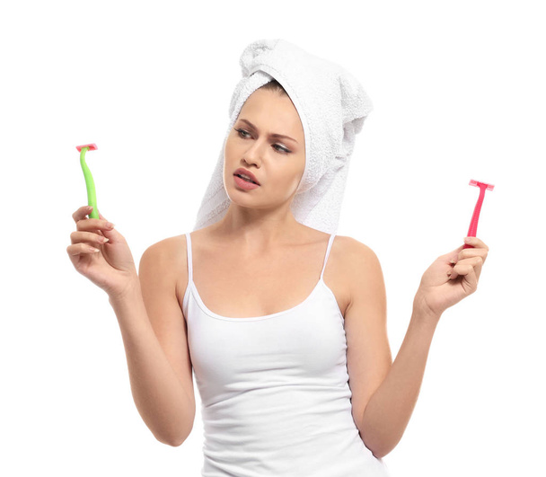 Beautiful young woman with razors on white background - Photo, Image