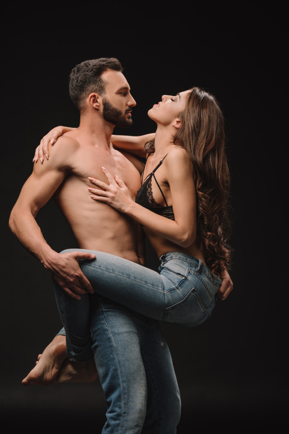 sexual passionate couple hugging together isolated on black - Фото, изображение