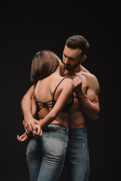 beautiful sensual couple hugging isolated on black - Fotografie, Obrázek