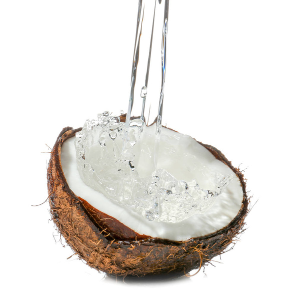 Half of fresh coconut with water splash on white background - 写真・画像