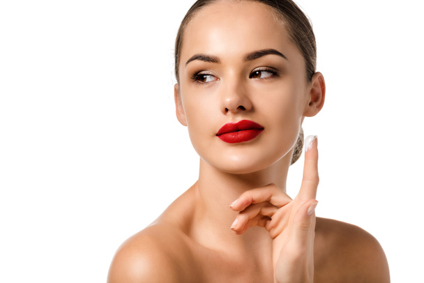 beautiful girl with red lips applying cream on face isolated on white - Zdjęcie, obraz