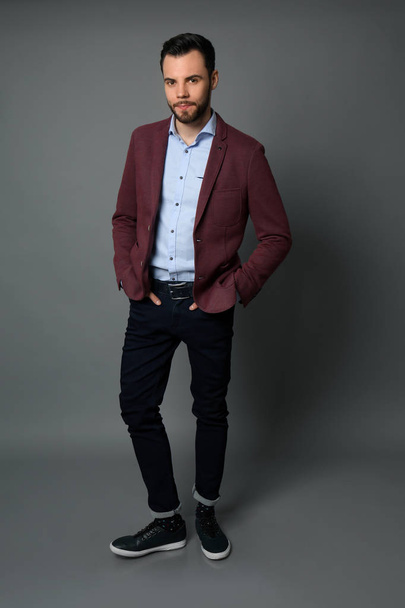 Fashionable young man on grey background - Φωτογραφία, εικόνα