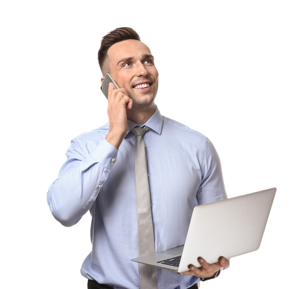 Young man with laptop talking by phone on white background - Foto, Imagem