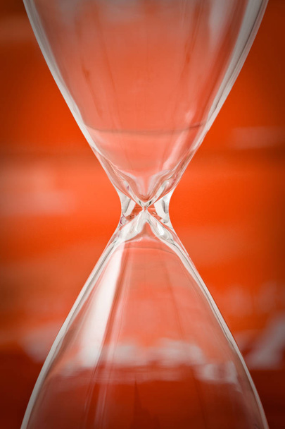 Empty hourglass on red background - Photo, Image