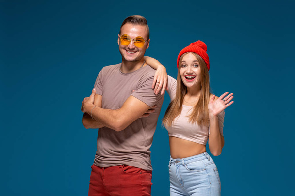 Studio lifestyle portrait of two best friends hipster wearing stylish bright outfits, hats, denim shorts and glasses, going crazy and having great time together. - Foto, Bild