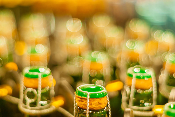 blurred background - corks on bottles of sparkling wine - Photo, Image
