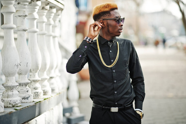 Chic handsome african american man in black shirt with gold chain and sunglasses. - Fotó, kép
