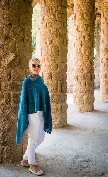 Woman walking through a colonnade in Park Guell in Barcelona - Valokuva, kuva