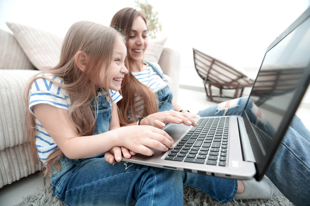 happy mother with adorable little girl with laptop - Foto, Imagem