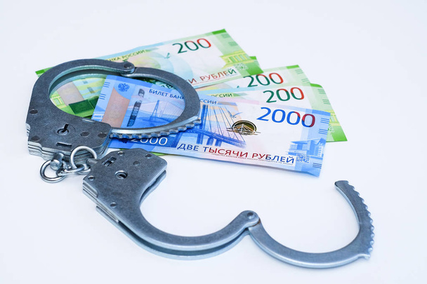 Handcuffs and banknotes. The concept of bribery and corruption. - Photo, image