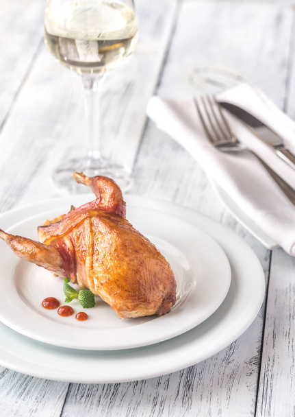 Baked quail wrapped in bacon on the plate - Photo, Image