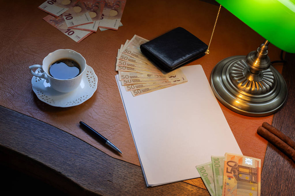 Euro, European money, on a stylish desk lit with a banking lamp - Fotoğraf, Görsel