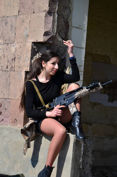 Airsoft game beautiful Girl With Gun.Nice and danger  - Photo, Image