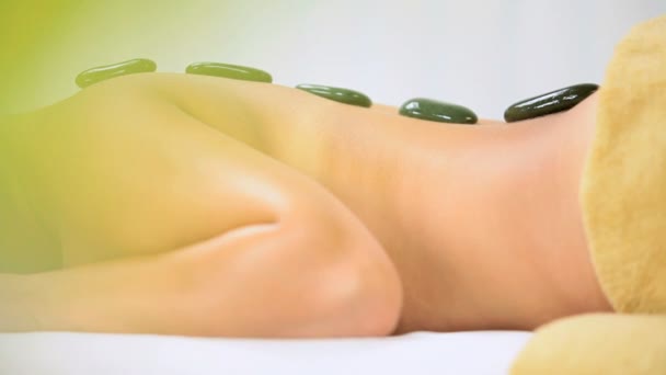 Caucasian Girl Relaxing with Hot Stone Spa Therapy - Кадри, відео