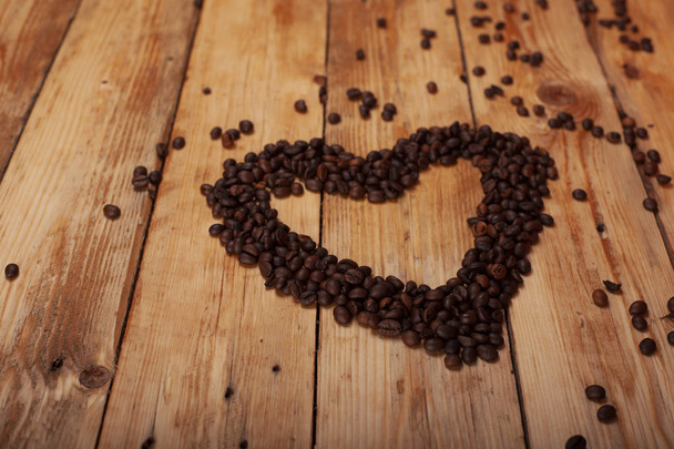 heart and coffee on a wooden table as background - Photo, Image