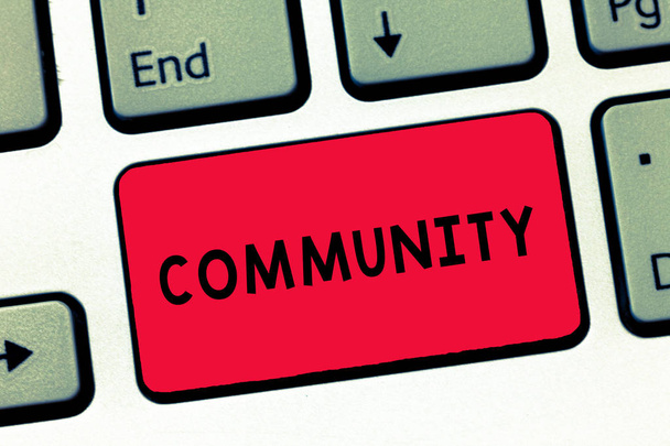 Text sign showing Community. Conceptual photo group living in same place or having characteristic in common Keyboard key Intention to create computer message, pressing keypad idea. - Photo, Image