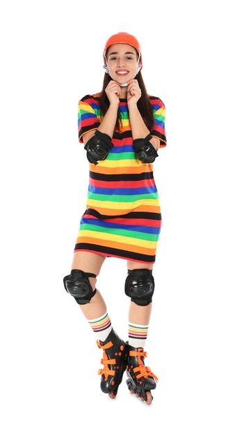 Full length portrait of young woman in bright dress with roller skates on white background - Foto, Imagen
