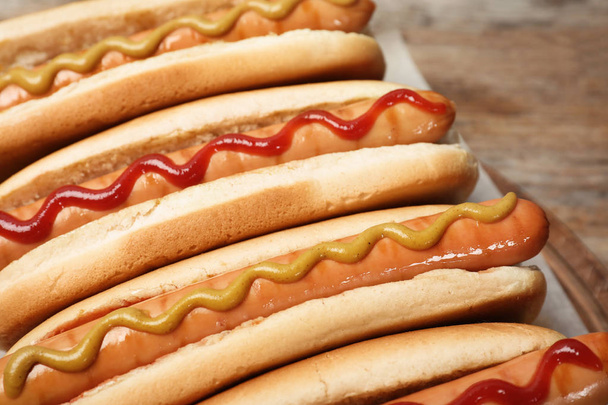 Tasty hot dogs on wooden board, closeup - Foto, Imagem