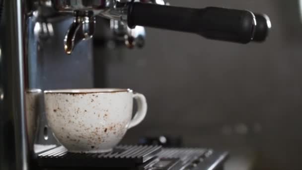 Coffee machine is preparing fresh coffee and pouring into a cup at restaurant - Footage, Video
